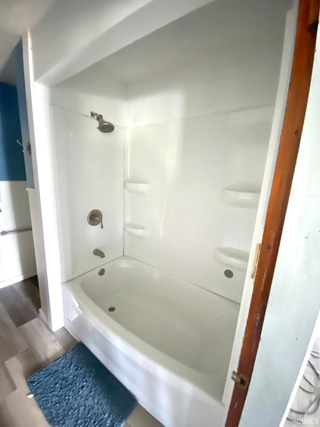 589 2nd St NW, Linton, IN 47441 - bathroom featuring tub / shower combination and wood finished floors