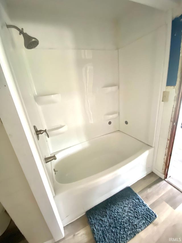 589 2nd St NW, Linton, IN 47441 - full bathroom featuring wood finished floors and washtub / shower combination