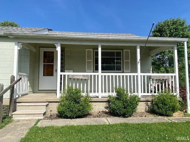 589 2nd St NW, Linton, IN 47441 - view of exterior entry with covered porch and roof with shingles