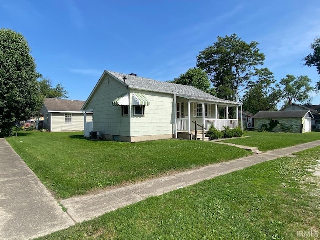 589 2nd St NW, Linton, IN 47441 - view of front of house featuring a porch, a front lawn, central air condition unit, and a shingled roof
