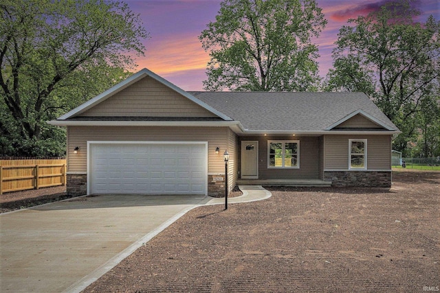 56968 Ash Rd, Osceola, IN 46561 - view of front facade with stone siding, driveway, a garage, and a shingled roof