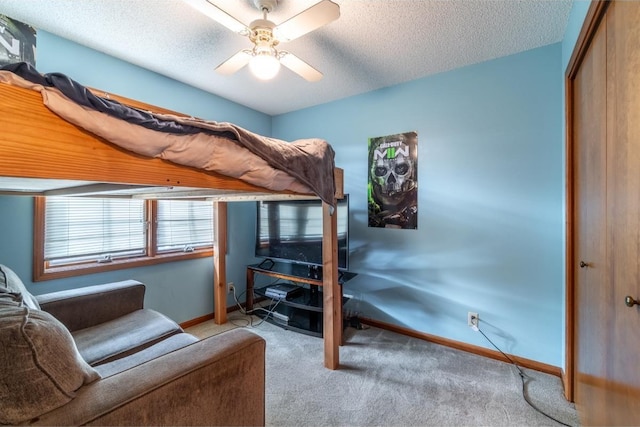705 Pine Run, Angola, IN 46703 - carpeted bedroom with baseboards, a closet, a textured ceiling, and a ceiling fan