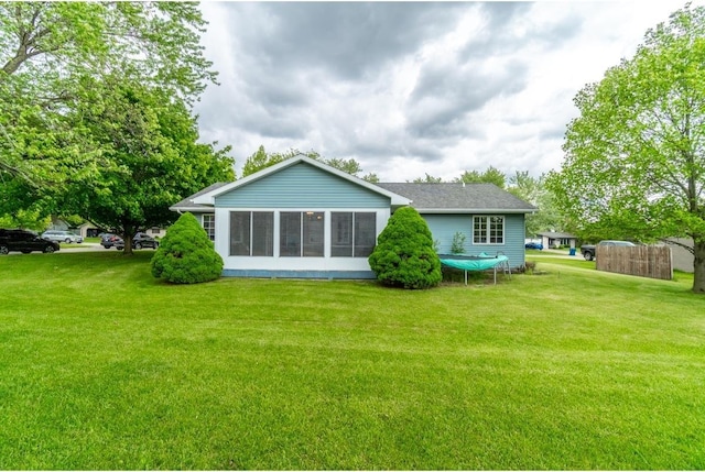 705 Pine Run, Angola, IN 46703 - rear view of house featuring a lawn, a sunroom, and roof with shingles