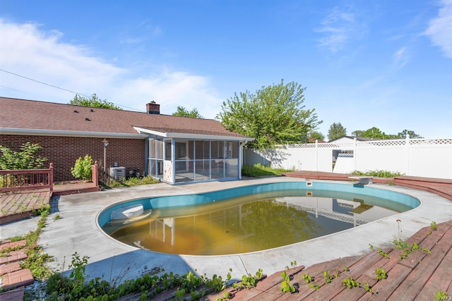 1725 W Saxon Dr, Marion, IN 46952 - view of pool with a sunroom, a wooden deck, and central air condition unit