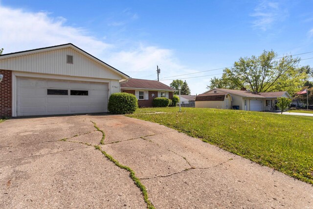 1725 W Saxon Dr, Marion, IN 46952 - single story home with brick siding, a front yard, driveway, and a garage