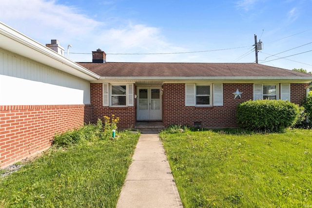 1725 W Saxon Dr, Marion, IN 46952 - entrance to property with brick siding, a yard, and a chimney