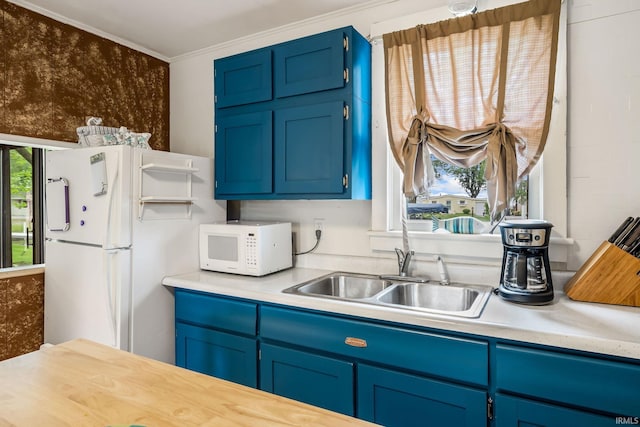 96 Ems B61I Ln, Warsaw, IN 46582 - kitchen with white appliances, blue cabinets, a sink, light countertops, and crown molding