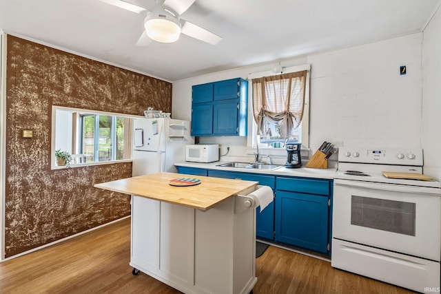 96 Ems B61I Ln, Warsaw, IN 46582 - kitchen featuring blue cabinetry, white appliances, a sink, butcher block counters, and wood finished floors