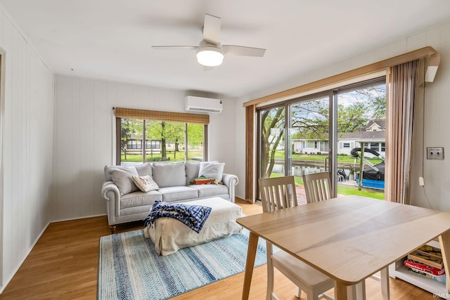 96 Ems B61I Ln, Warsaw, IN 46582 - living room featuring a wall mounted air conditioner, healthy amount of natural light, light wood-style floors, and a ceiling fan