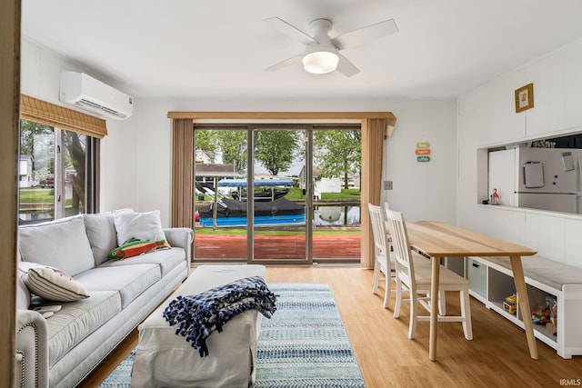 96 Ems B61I Ln, Warsaw, IN 46582 - living area with a wall mounted air conditioner, healthy amount of natural light, light wood-style flooring, and a ceiling fan
