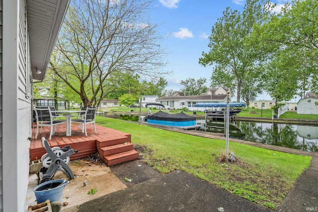 96 Ems B61I Ln, Warsaw, IN 46582 - view of grassy yard featuring boat lift, a dock, a deck with water view, and a residential view