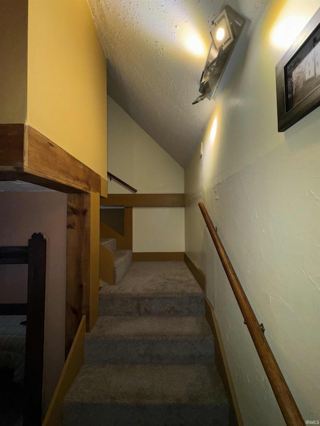 417 S Elliott St, Muncie, IN 47305 - staircase with carpet, a textured ceiling, and vaulted ceiling