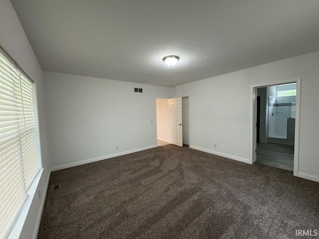 844 Ben Franklin St, Cloverdale, IN 46120 - unfurnished bedroom featuring dark colored carpet, baseboards, and a textured ceiling