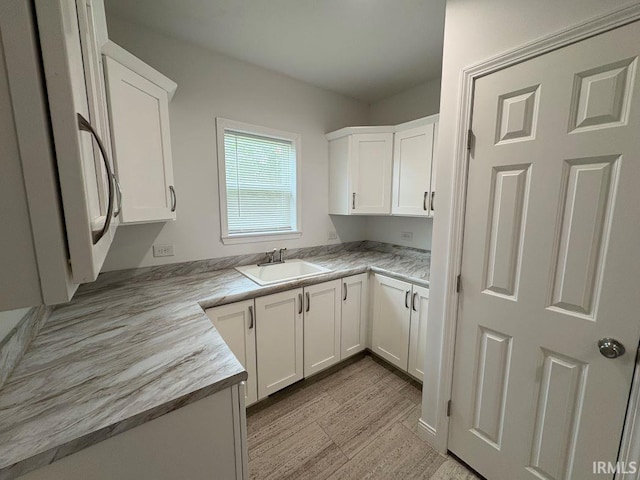 844 Ben Franklin St, Cloverdale, IN 46120 - kitchen with a sink, white cabinetry, and light countertops