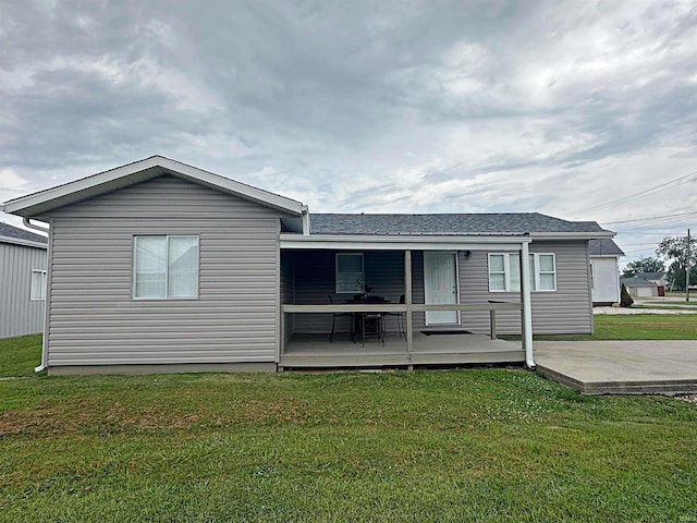 402 Sheridan St, Loogootee, IN 47553 - rear view of house with a lawn and a shingled roof