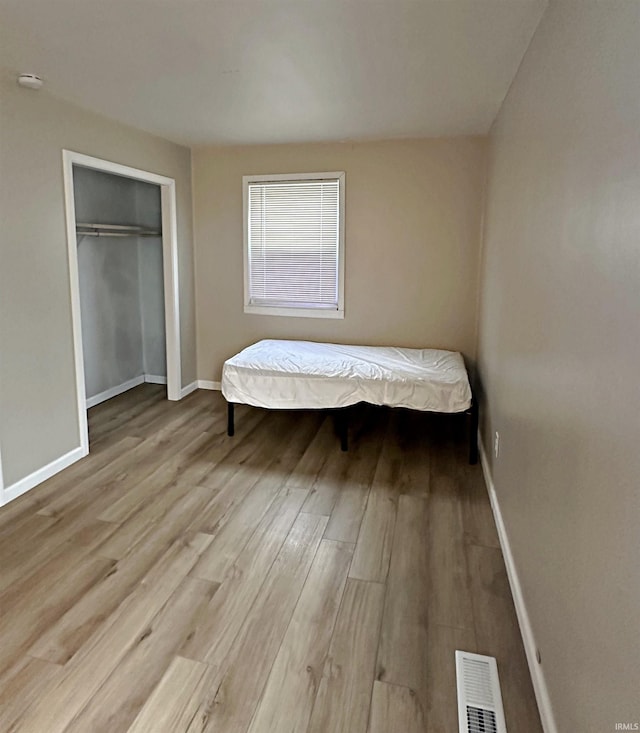 402 Sheridan St, Loogootee, IN 47553 - bedroom featuring wood finished floors, baseboards, and a closet