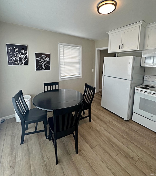 402 Sheridan St, Loogootee, IN 47553 - dining area featuring light wood-style flooring and baseboards