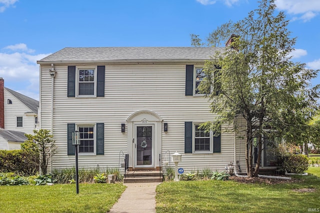 1919 Kessler Blvd, South Bend, IN 46616 - colonial inspired home with a front lawn and a chimney