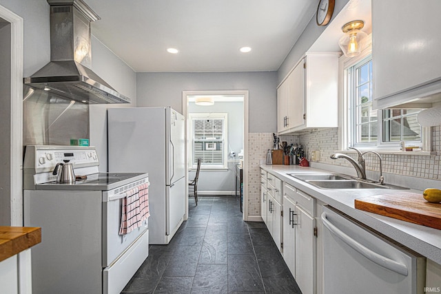 1919 Kessler Blvd, South Bend, IN 46616 - kitchen with white appliances, wall chimney exhaust hood, a sink, white cabinetry, and decorative backsplash