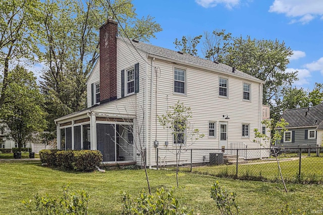 1919 Kessler Blvd, South Bend, IN 46616 - view of side of home featuring a sunroom, a chimney, central AC unit, and roof with shingles