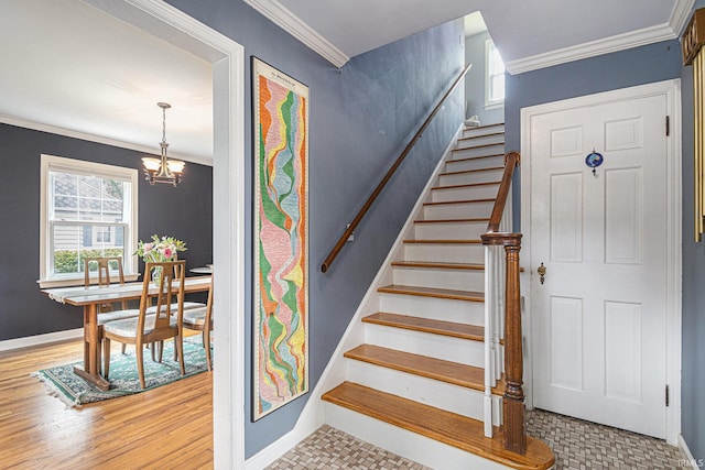 1919 Kessler Blvd, South Bend, IN 46616 - stairway featuring crown molding, a chandelier, baseboards, and wood finished floors