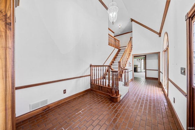 3619 Sullivan Ct, South Bend, IN 46614 - stairway featuring brick floors, baseboards, and high vaulted ceiling