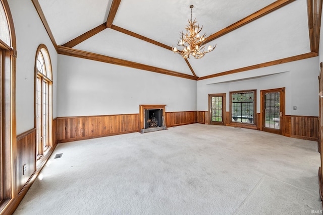 3619 Sullivan Ct, South Bend, IN 46614 - unfurnished living room with wainscoting, a chandelier, carpet floors, a fireplace, and wood walls