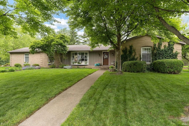 3599 Canterbury Dr, Lafayette, IN 47909 - ranch-style house featuring a front lawn, board and batten siding, and brick siding