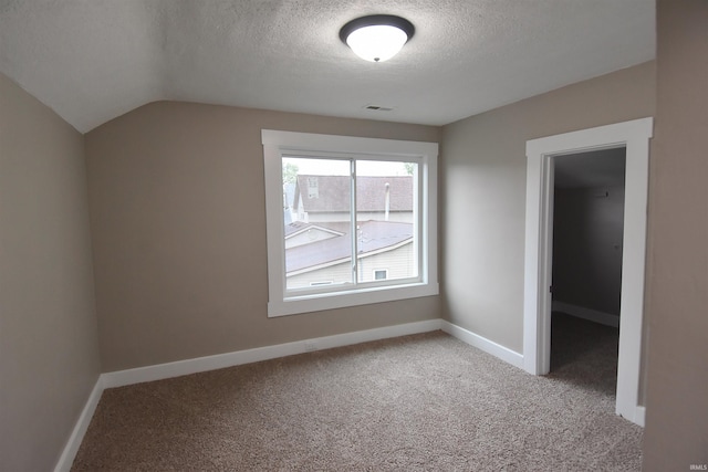 1602 Etna Ave, Huntington, IN 46750 - additional living space featuring a textured ceiling, carpet floors, baseboards, and lofted ceiling
