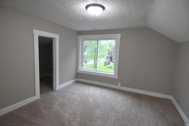 1602 Etna Ave, Huntington, IN 46750 - additional living space with a textured ceiling, light carpet, baseboards, and vaulted ceiling