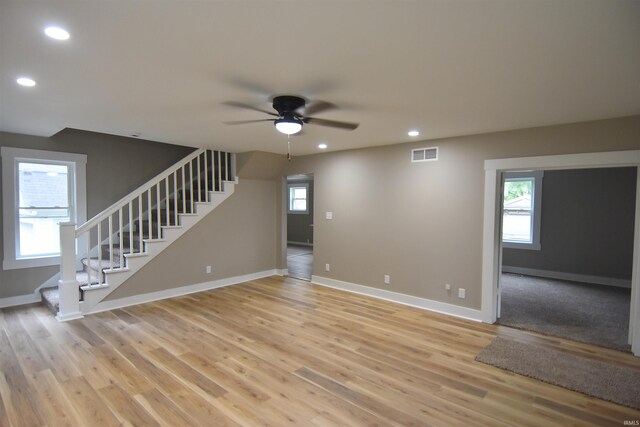 1602 Etna Ave, Huntington, IN 46750 - unfurnished living room with recessed lighting, a ceiling fan, stairs, baseboards, and plenty of natural light