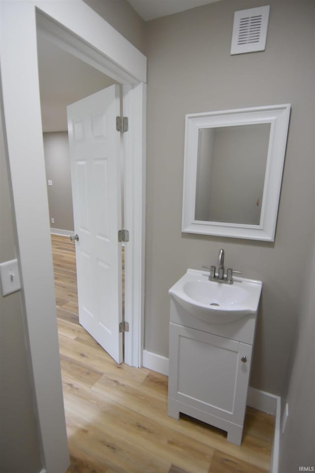 1602 Etna Ave, Huntington, IN 46750 - bathroom with vanity, wood finished floors, and baseboards