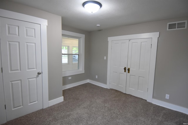 1602 Etna Ave, Huntington, IN 46750 - unfurnished bedroom with dark carpet, baseboards, and a closet