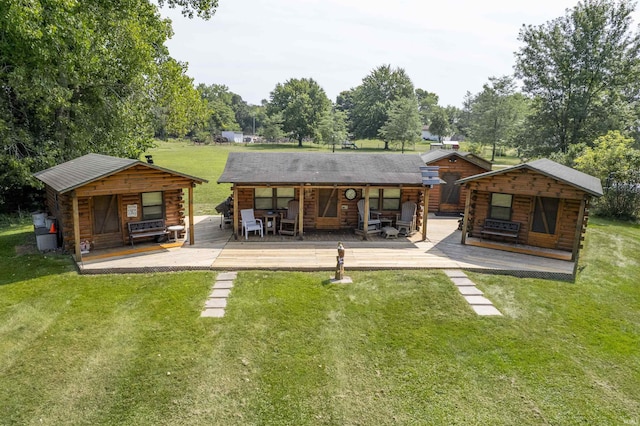 11029 E 350 S, Lagrange, IN 46761 - back of house with log siding, a yard, a wooden deck, and view of wooded area