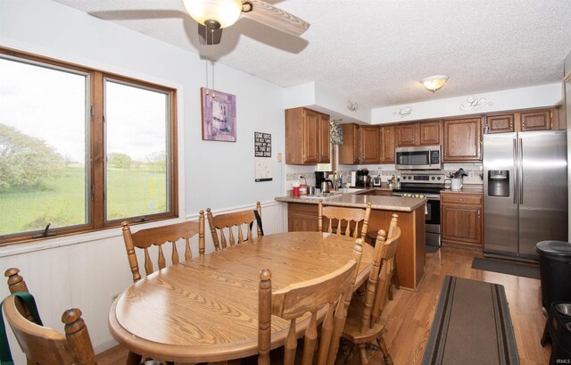1220 N 290, Angola, IN 46703 - dining room featuring light wood-type flooring, a ceiling fan, and a textured ceiling