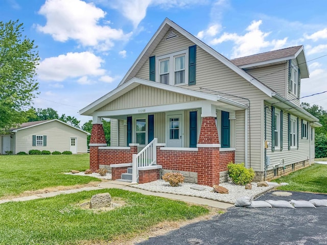 1029B Second Ave, Jasper, IN 47546 - bungalow-style home with a porch, a front yard, brick siding, and board and batten siding