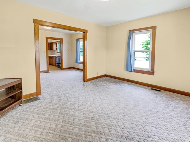 1029B Second Ave, Jasper, IN 47546 - carpeted empty room with baseboards and healthy amount of natural light