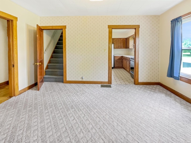 1029B Second Ave, Jasper, IN 47546 - empty room featuring light colored carpet, baseboards, and stairs