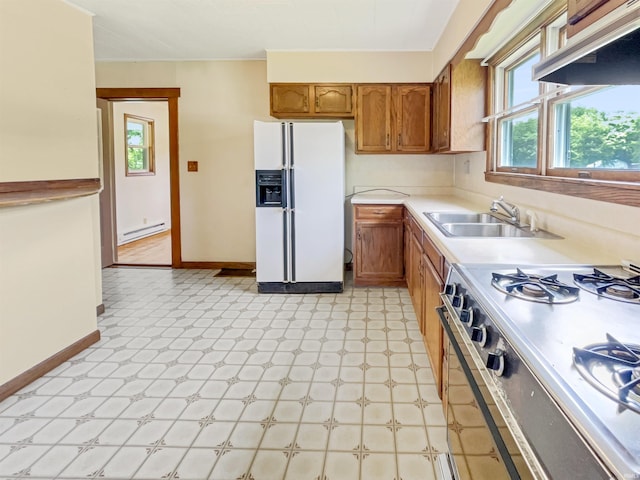 1029B Second Ave, Jasper, IN 47546 - kitchen featuring white fridge with ice dispenser, range, a baseboard heating unit, a sink, and under cabinet range hood