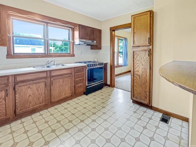 1029B Second Ave, Jasper, IN 47546 - kitchen with a sink, gas range oven, under cabinet range hood, light flooring, and baseboards
