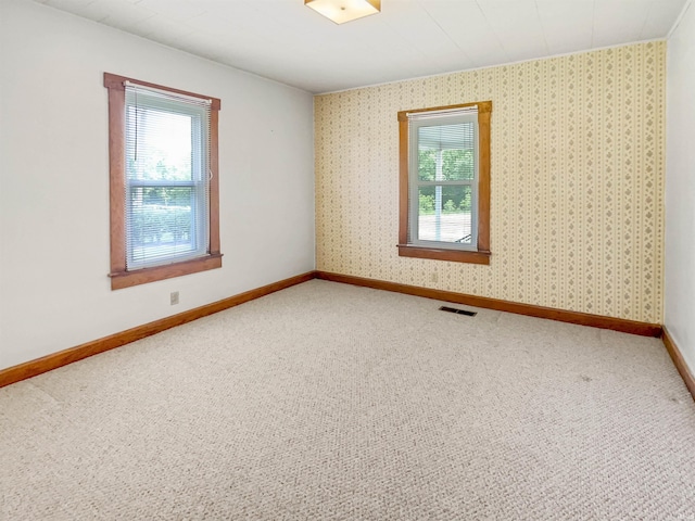 1029B Second Ave, Jasper, IN 47546 - carpeted empty room with healthy amount of natural light, baseboards, and wallpapered walls