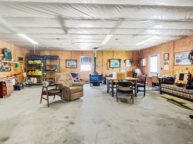 1029B Second Ave, Jasper, IN 47546 - living room featuring a wood stove, concrete flooring, and wood walls