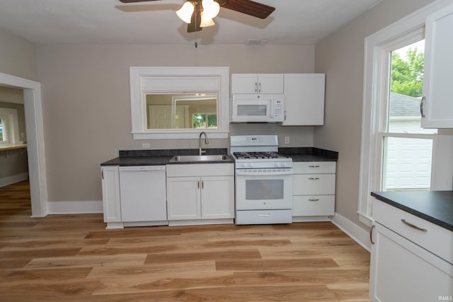 515 W Crawford St, Elkhart, IN 46514 - kitchen featuring white appliances, a sink, a ceiling fan, light wood-type flooring, and white cabinetry