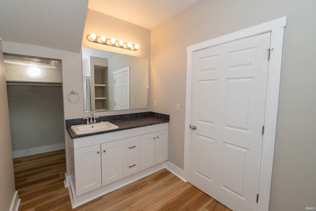 515 W Crawford St, Elkhart, IN 46514 - bathroom with vanity, wood finished floors, and baseboards