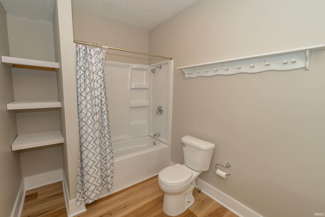 515 W Crawford St, Elkhart, IN 46514 - bathroom with wood finished floors, toilet, shower / bathtub combination with curtain, and baseboards