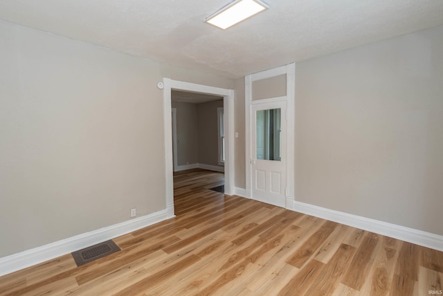 515 W Crawford St, Elkhart, IN 46514 - empty room with light wood-style floors and baseboards