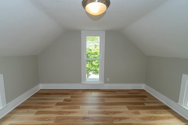 515 W Crawford St, Elkhart, IN 46514 - bonus room with wood finished floors, lofted ceiling, a textured ceiling, and baseboards