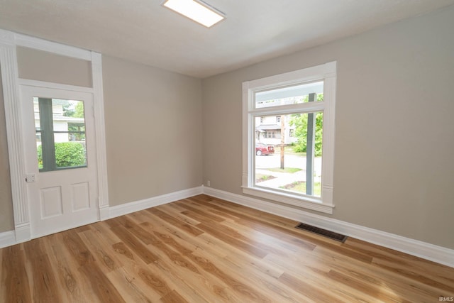 515 W Crawford St, Elkhart, IN 46514 - empty room featuring baseboards, plenty of natural light, and light wood-type flooring