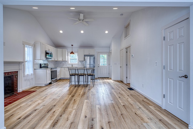 508 Polk St, Newburgh, IN 47630 - kitchen featuring stainless steel appliances, white cabinetry, a ceiling fan, high vaulted ceiling, and backsplash