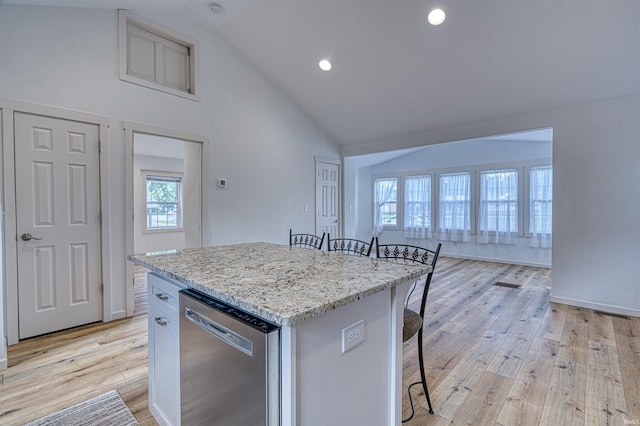 508 Polk St, Newburgh, IN 47630 - kitchen with dishwasher, a kitchen bar, a center island, light wood-style flooring, and light stone countertops